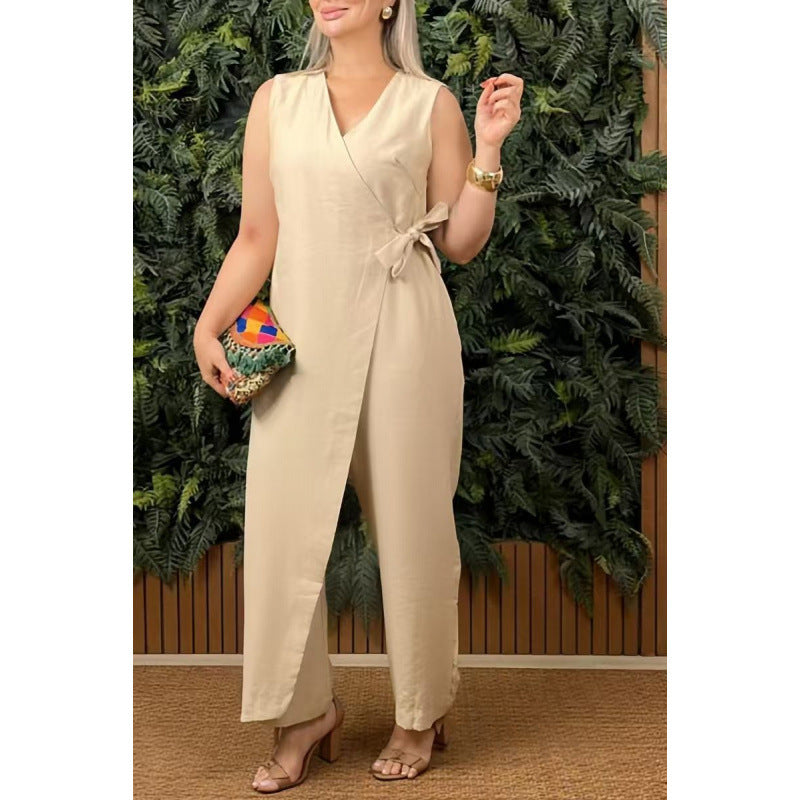Woman wearing a beige jumpsuit holding a colorful clutch