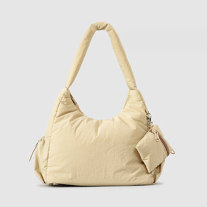 The Alyssa Cotton Puff Bag, made from soft nylon, combines comfort and elegance with its plush texture and secure zip closure, offering the ideal accessory for any outfit.