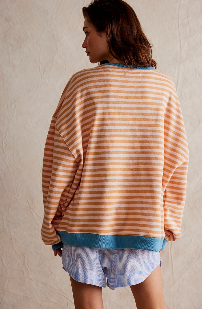 Eye-catching bold stripes on a cozy oversized sweater, perfect for any wardrobe.