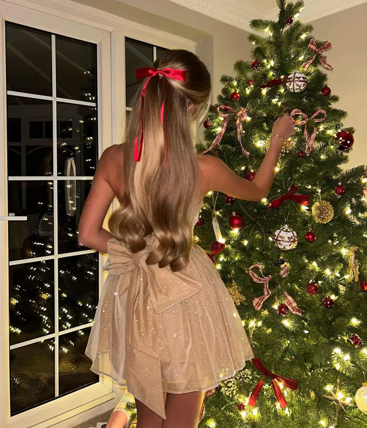 The Lynn Sparkling Glitter Gown with a dramatic oversized bow at the back, adding playful elegance.