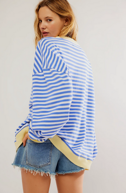 Model showcasing the relaxed fit of the Mana Striped Oversized Sweater.