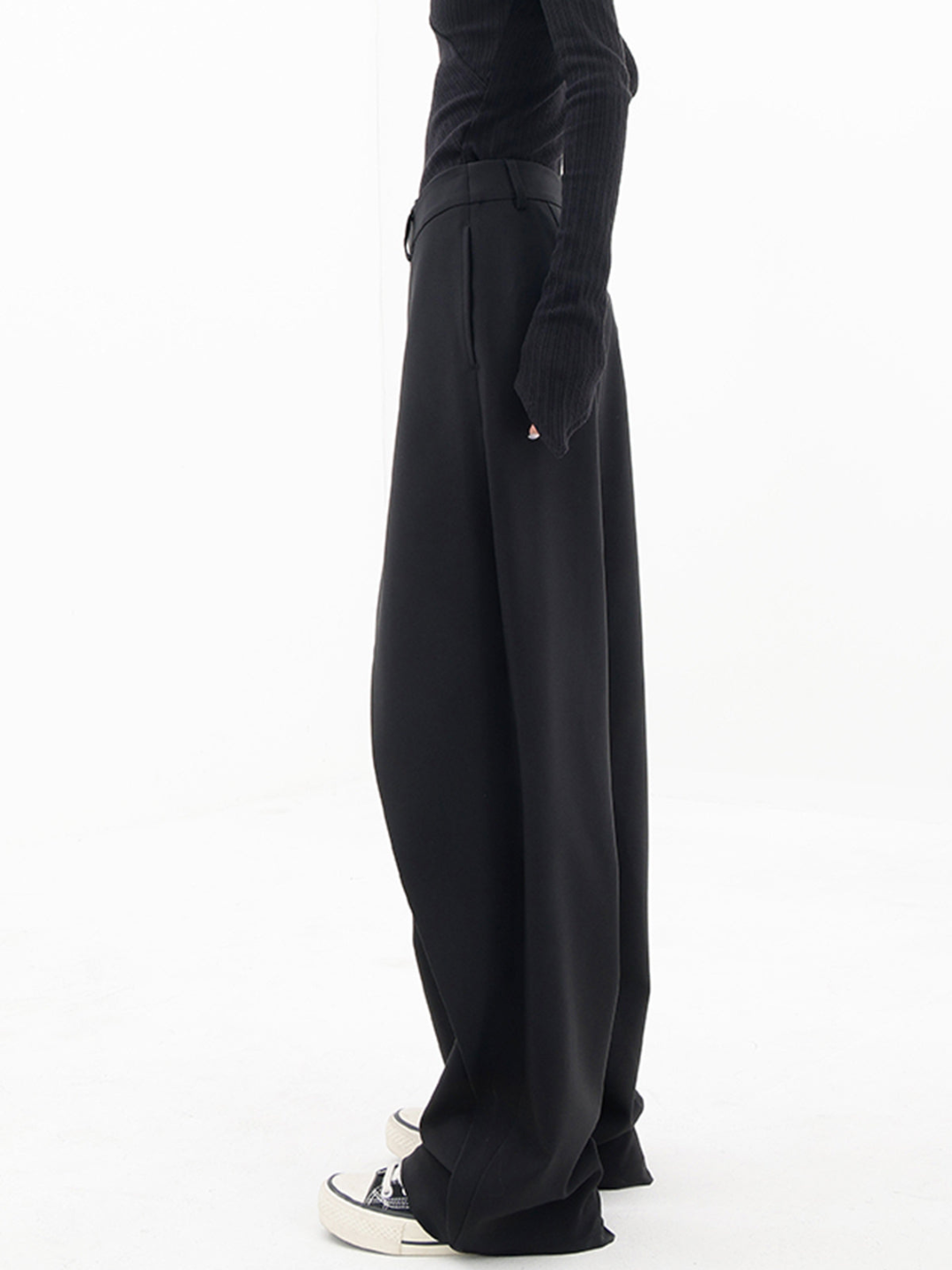 ide view of the asymmetrical baggy pants, emphasizing their unique cut and modern aesthetic.