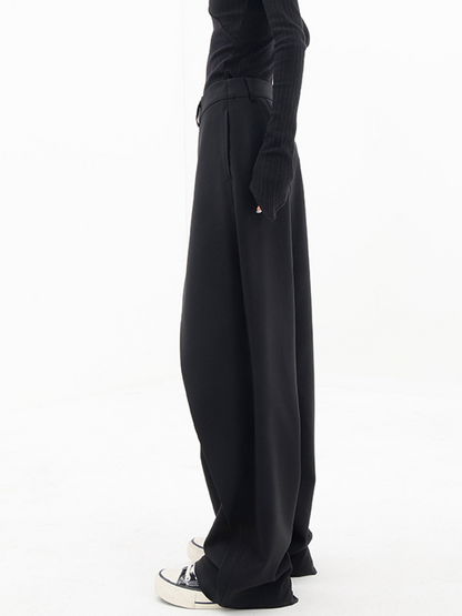 ide view of the asymmetrical baggy pants, emphasizing their unique cut and modern aesthetic.