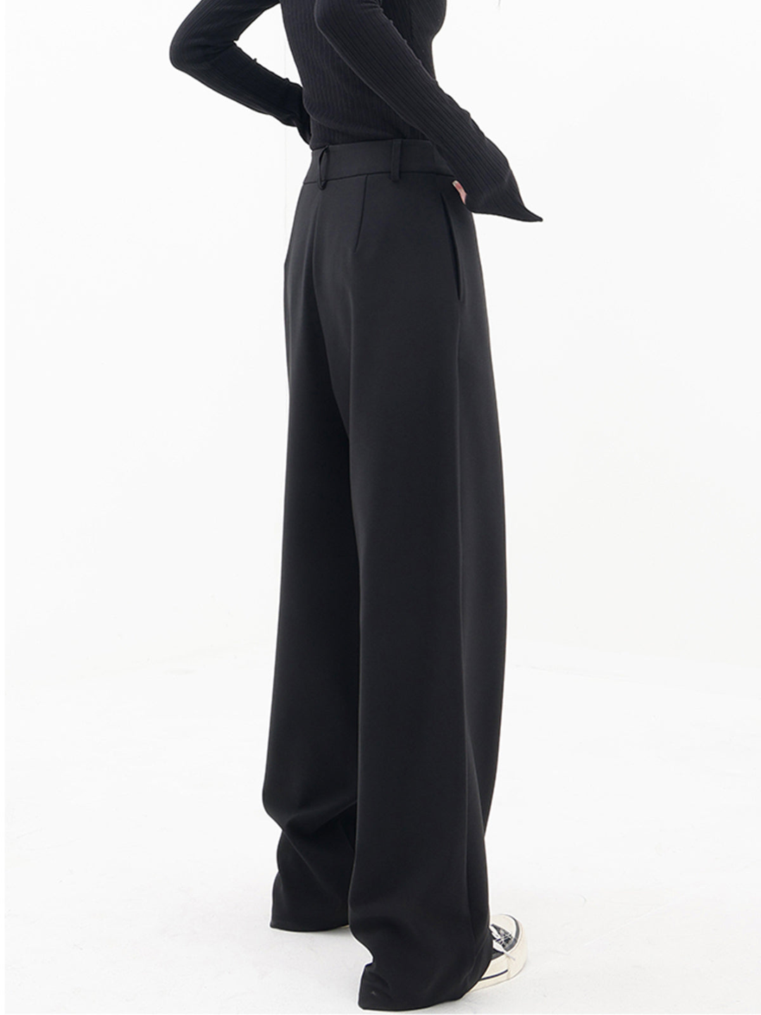 Asymmetrical baggy pants styled casually with a T-shirt, ideal for versatile wardrobe pairings.